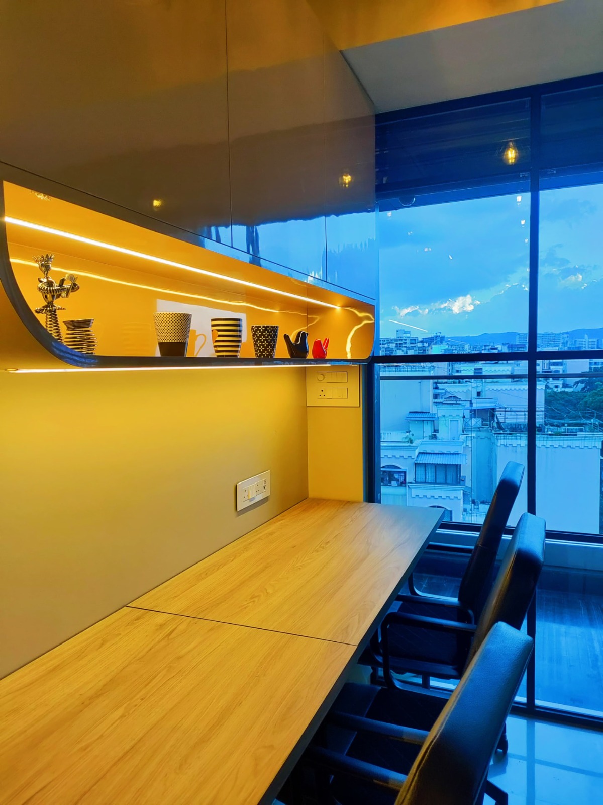 Commercial office interior with long meeting desk and exposed ceiling